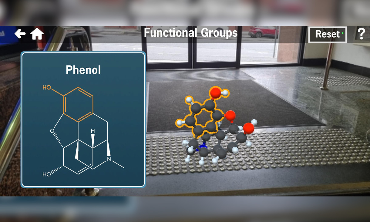Vision of the the app's gameplay with an image of a molecular structure on the ground with a diagram labelled 'Phenol' next to it.